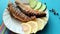 Fried sea fish on a plate / Fried fish, lemons and cucumbers /