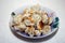 Fried seasoning pelmeni from herbs, hot lie in a plate on a table.