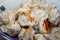 Fried seasoning pelmeni from herbs, hot lie in a plate on a table.