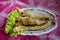 Fried Sheatfishes or Siluridae fresh river fish with garlic and pepper