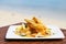 Fried Shrimp on decoration vegetable on wooden table with beach view