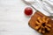 Fried shrimps tempura with red sauce on wooden board over white wooden background, top view.