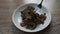 Fried slice pork liver with garlic and pepper topping parsley on plate stabbing by silver fork