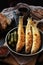 Fried smelt on a dark pan with sauce