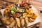 fried snack for beer. Large plate of beer snacks: croutons  fried onion rings in batter  french fries  potato wedges. Hot sauce