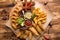 fried snack for beer. Large plate of beer snacks: croutons  fried onion rings in batter  french fries  potato wedges. Hot sauce