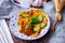 Fried Solanum melongena with Egg in a green dish on the table with garlic, dried chilli