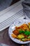 Fried Solanum melongena with Egg in a green dish on the table with garlic, dried chilli