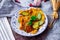 Fried Solanum melongena with Egg in a green dish on the table with garlic, dried chilli