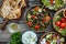 Fried souvlaki, greek salad and tzatziki on wooden table