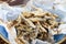 Fried sprat in parchment on wooden background