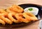 Fried squid rings breaded on wooden background