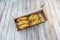 Fried stuffed Argentine empanadas in a cardboard box for home delivery