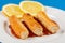 Fried Surimi Sticks With Lemons On The Blue Wooden Boards