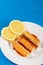 Fried Surimi Sticks With Lemons On The Blue Wooden Boards