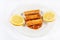 Fried Surimi Sticks With Lemons On The White Plate