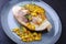 Fried swordfish steak with mango chutney and herbs on a design plate