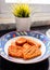 Fried tempeh / tempe on a plate in a kitchen. Tempeh a traditional Indonesian soy product, that is made from fermented soybeans.