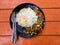 Fried Thai holy basil pork with fried egg topped on rice