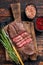 Fried Top Blade or flat iron roast beef meat steaks on wooden board with rosemary. Dark wooden background. Top View