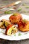 Fried turkey meat cutlets stuffed with cheese and fried mushrooms on plate on wooden background. Home cutlets