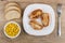 Fried turkey meat in plate, pieces of bread, sweet corn