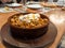 Fried Turkish manti with spices and cream in a traditional dish on a wooden tray. selective focus. small focus area