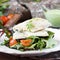 Fried white fish fillet with salad of tomatoes, arugula, herbs