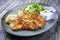 Fried Wiener schnitzel from veal topside with fried potatoes and lettuce on a modern design plate