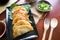 fried wonton. wonton on plate with chili oil. Shrimp or meat dumpling soup with mustard , green onions, on table