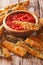 fried zucchini sticks breaded with parmesan and tomato sauce closeup. vertical