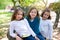 Friend sister girls resting on tree trunk nature