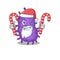 Friendly bacteria bacilli in Santa Cartoon character holds Christmas candies
