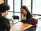 Friendly businessman having a good conversation with female employee in wheelchair