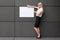 Friendly businesswoman displaying a blank sign