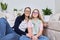 Friendly cheerful family, portrait of mom and teenage daughter, with green parrot