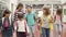 Friendly children with colorful walking in school hallway.