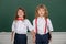 Friendly classmates in school uniform at lesson. Schoolkids and friendship, school friends. Classmates couple, young
