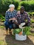 Friendly couple with a basket of vegetables in the garden