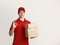 Friendly courier holds cardboard boxes and shows ok gesture