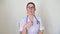Friendly doctor gestures and talks to the camera. Portrait of a healthcare professional giving online disease prevention