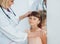 Friendly doctor pediatrician with patient child at clinic