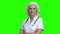 Friendly doctor woman on green screen background.