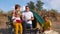 Friendly family with children dining out in nature with a tent on a sandy beach