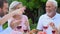 Friendly family communicating and laughing having lunch outdoor pleasure pastime