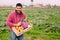 Friendly farmer with a wooden box with vegetables