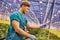 Friendly farmer working on hydraulic scissors lift platform in g