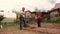 Friendly father and son are digging a hole with a shovel for planting a tree.