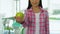 Friendly girl offering apple in dental office, healthy teeth concept, vitamins