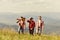 Friendly guys with guitar hiking on sunny day. Tourists hiking concept. Enjoying freedom together. Group of young people